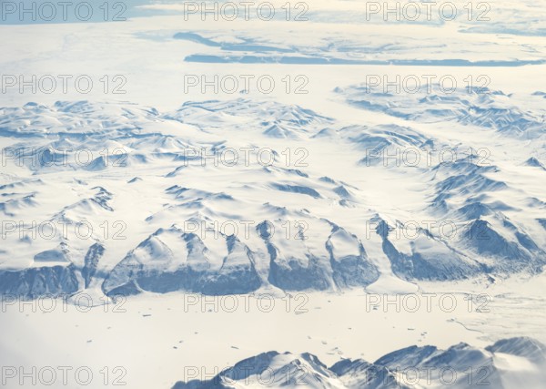 Glacier tongues flow into huge glaciers, snowy arctic mountain landscape, aerial view, Greenland,