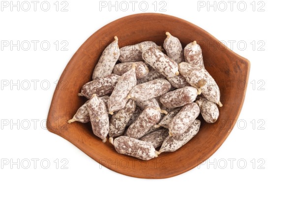 Small smoked Chicken sausages in clay bowl isolated on white background. top view, close up