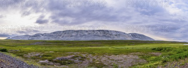A massive granite rock mountain with bare fells dominates the landscape of the central Varanger