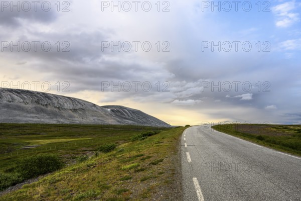 The Austertanaveien 890 winds through vast, quiet countryside, barren landscape with a winding road