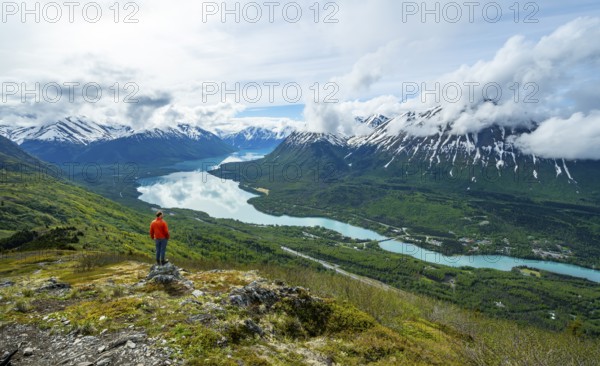 Climber enjoying the view, Slaughter Ridge Trail, view of snowy mountains and turquoise blue Kenai