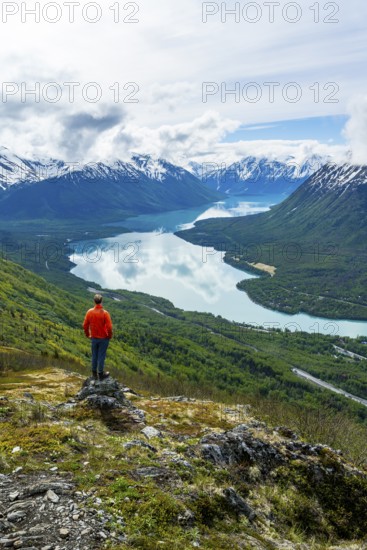Climber enjoying the view, Slaughter Ridge Trail, view of snowy mountains and turquoise blue Kenai