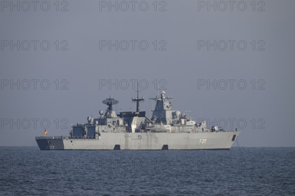 A gray naval vessel from the submarine defense the frigate Bayern F217 on calm seas at roadside off
