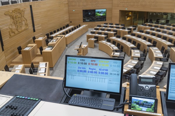 Plenary hall deserted with the seats of deputies and the government bank. Behind it is the