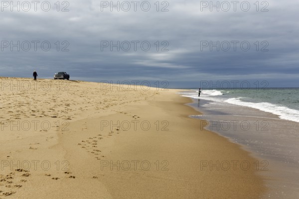 Ocean walkers, fall cloud cover, SUV on horizon, offroad, Provincetown, Race Point Beach, Cape Cod