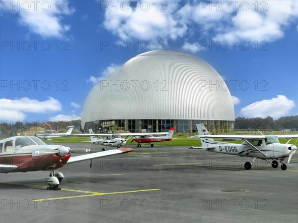 View of flight apron of Essen Mülheim airport with small aircraft parked at the front in the middle