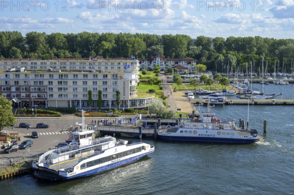Ferries across the river Trave to Priwall in a busy small port in the town of Travemünde with
