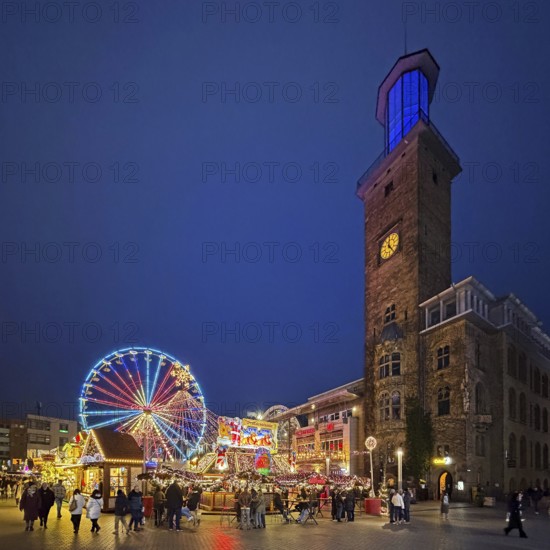 The town hall tower at the Christmas market with the Ferris wheel in the evening, Hagen, Ruhr area,