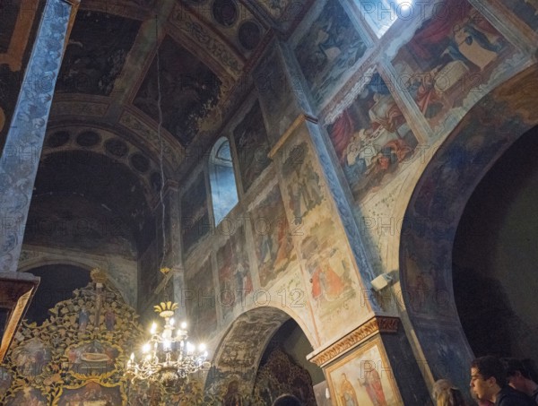 Picturesque religious scenes on walls and vaults illuminated by natural light in the church, Bodbe