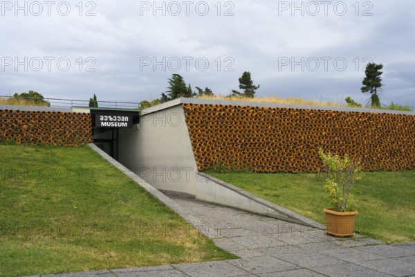 Modern museum with grass roof and tile cladding, minimalist architectural design, Historical