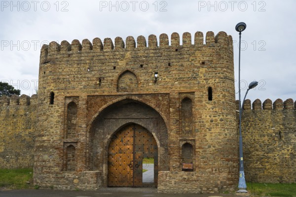 Historic fortress with high archway and massive stone walls, medieval charm, entrance gate, Batonis