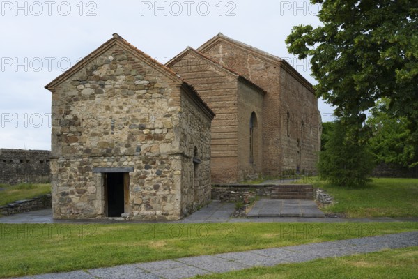 Small stone church with simple construction and rustic charm in a green setting, Batonis Ziche