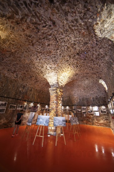 Exhibition at the Porto tourist office, a former Genoese weapons warehouse, interior view, Ota,