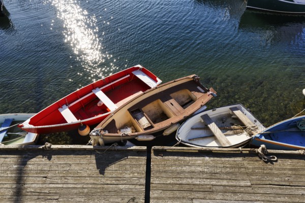 Small rowing boats moored on a wooden pier, sunny weather, view from above, Bradley Wharf, Bearskin