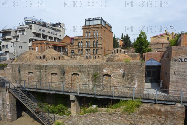 Historic brick buildings with domes in urban surroundings, sulfur baths, Abanotubani spa district,