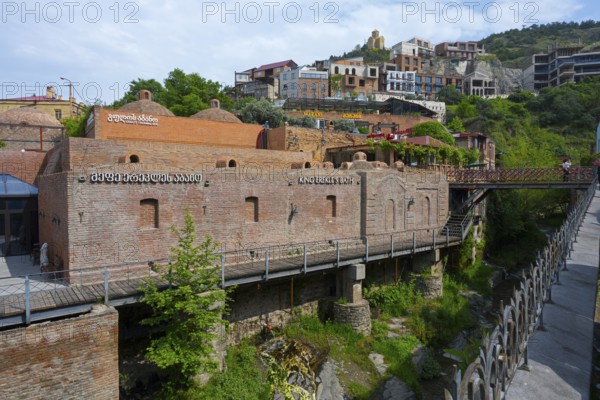 River valley with a brick bridge surrounded by historic architecture, King Erekles Bath,