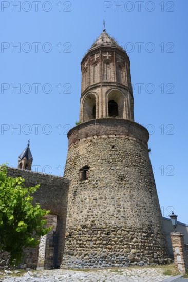 Close-up of a medieval tower under bright blue sky in an old town, St. George Church, St. George,