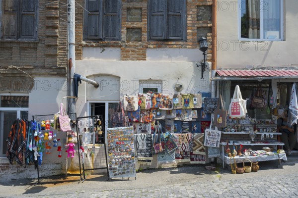 Colourful souvenir stalls along a paved street, decorative pieces and old buildings, Old Town,