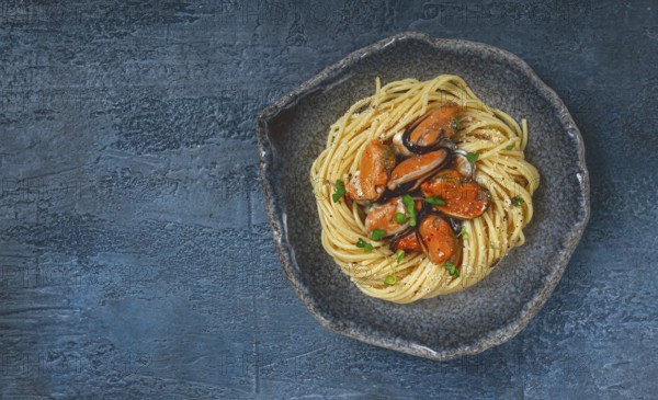 Spaghetti with mussels, without shell, pasta with peeled mussels, in carbonara sauce, micro-greens,
