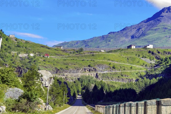 Road from in Italy just in front of the border with France, in the background driveway with