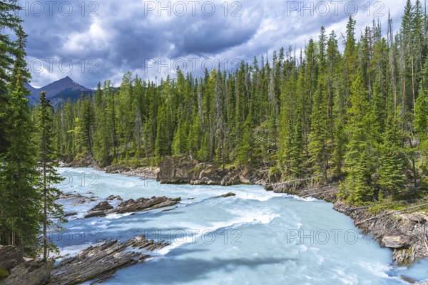 Turquoise water flows through the bow river natural bridge in banff national park, alberta, canada,