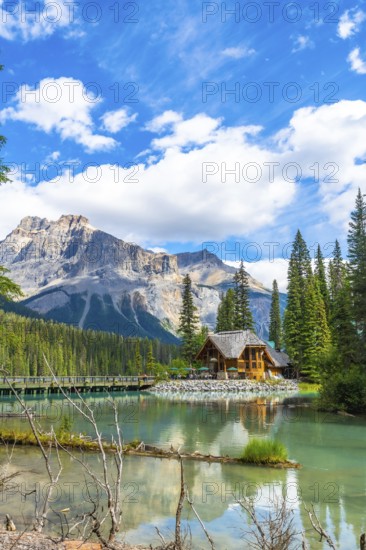 Emerald lake lodge reflecting on turquoise waters, framed by the canadian rockies and pine forest