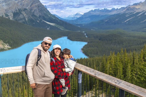 Tourists admiring stunning turquoise waters of peyto lake, surrounded by majestic canadian rockies
