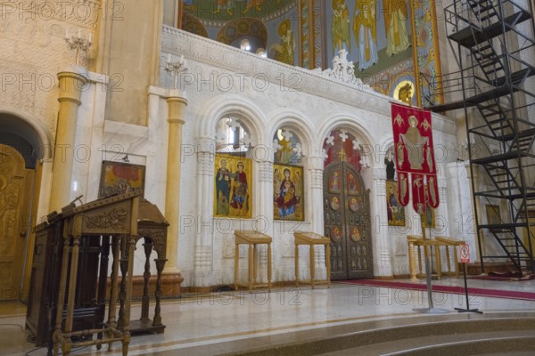 Interior view of an Orthodox church with icons and sacred objects in front of an altar, Sameba