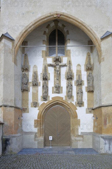 Church portal with crucifix and figures, monastery church decorations built in the 15th century,