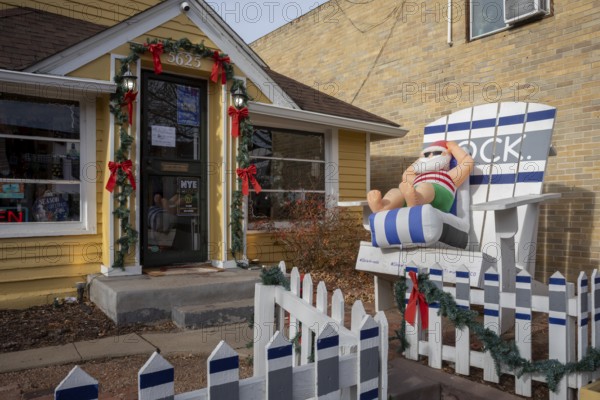 Arvada, Colorado - A blow-up Santa lounges in a beach chair outside a store in Olde Town Arvada as