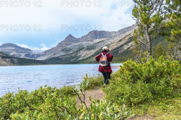 Female tourist enjoying the breathtaking view of bow lake and bow glacier in banff national park,