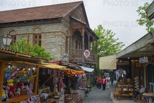 Busy old town street with traditional buildings and market stalls selling souvenirs, Mtskheta,