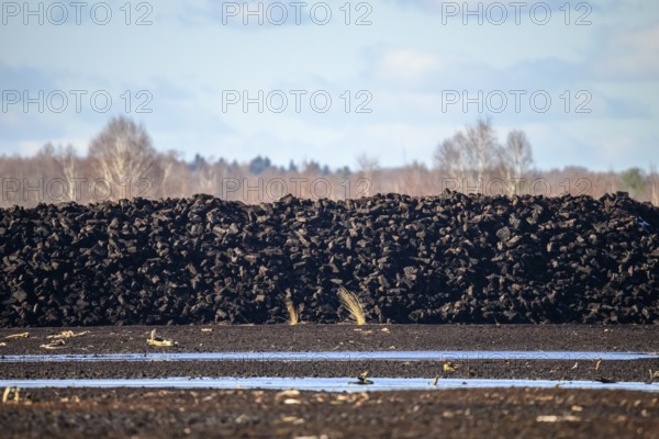 Layered peat sods Peating of a high-moor black peat in cloudy skies with earthy colors and natural