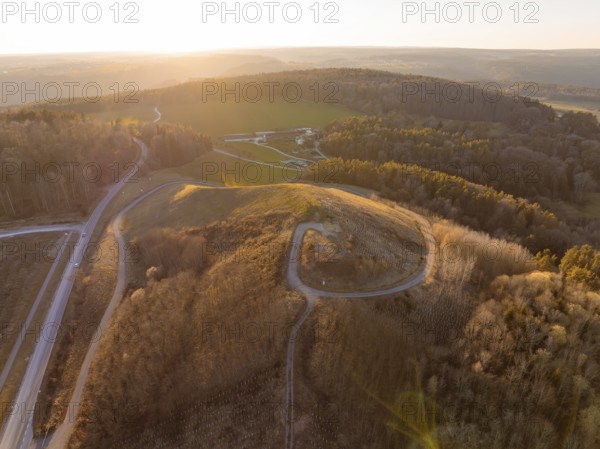 Landscape at sunset with hills and dense forest, future PV building on old deposit, Lindenrain