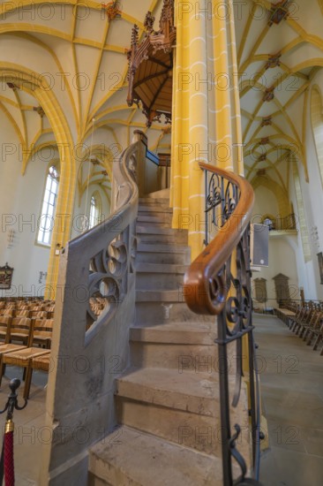 Detailed view of a stone spiral staircase leading to the pulpit with artistic carvings in a church,