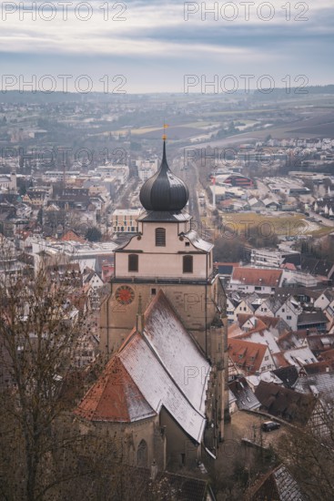 Panorama of the city with a church tower standing in the foreground and winter atmosphere,