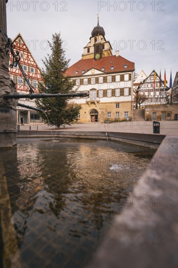 Historic townscape with half-timbered houses, a fountain and a decorated Christmas tree,