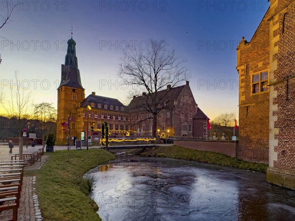 View in winter over a partially frozen moat at a castle converted into a Renaissance castle today