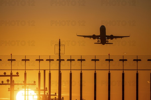 Runway lighting, approach aids, at Düsseldorf International airport, sunset, aviator taking off, in