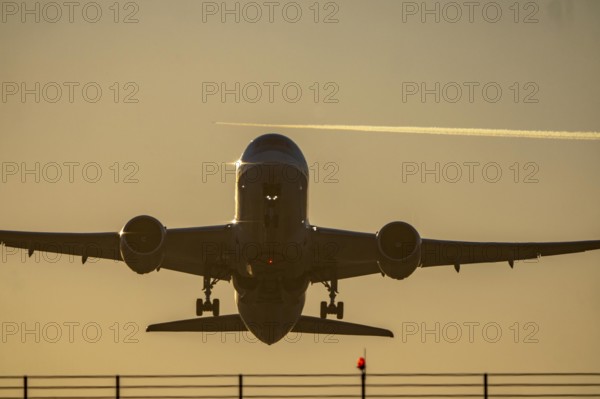 Runway lighting, approach aids, at Düsseldorf International Airport, sunset, aircraft taking off,