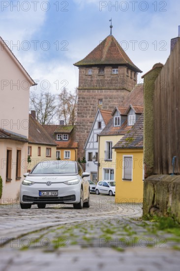 Picturesque alley in the old town with cobblestones and defensive towers, ID3, deer e-car sharing,