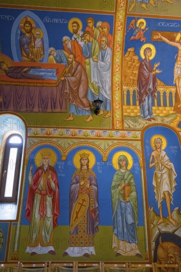 Detailed Orthodox frescoes depicting saints and religious scenes in vivid colors, St. Barbara