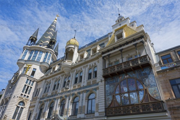 Magnificent building with decorated tower and detailed façade under blue sky, Astronomical Clock,