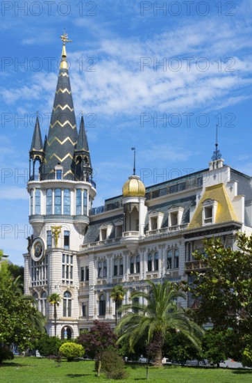 Tower with golden dome in an impressive building with palm trees, Astronomical Clock, Black Gold