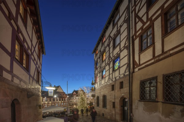 Historic half-timbered houses with a view of the Christmassy decorated Tiergärtnertorplatz in the