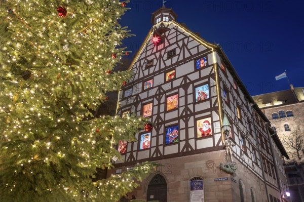 The historic Pilate House with advent calendar and Christmas tree in the evenings,