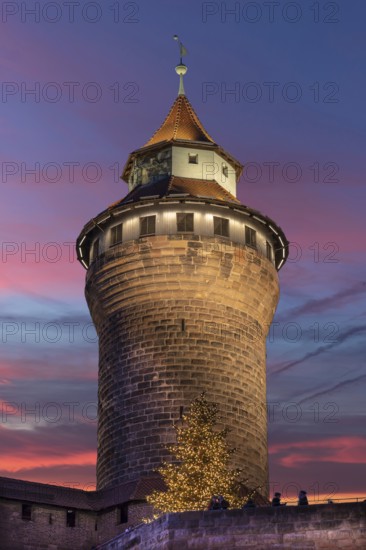 Illuminated Sinwell Tower, built in the 13th century, in the evening sky, Kaiserburg, Nuremberg,