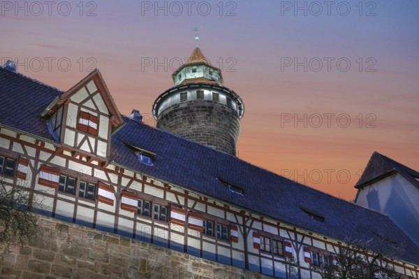 Sinwell Tower built in the 13th century, on the Nuremberg Kaiserburg in the evening lighting, red