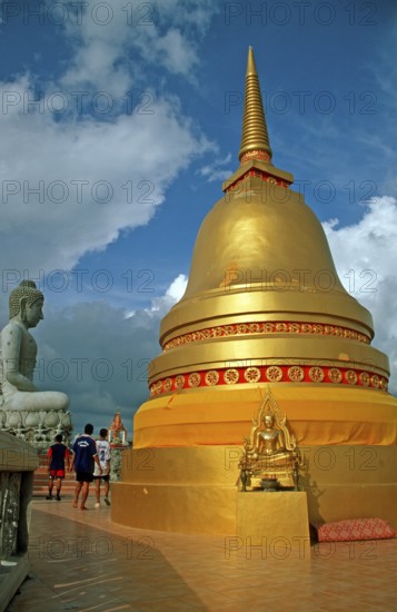 People, Buddha statue, chedi in Wat Tam Sua monastery, which is partly on the top of a mountain,