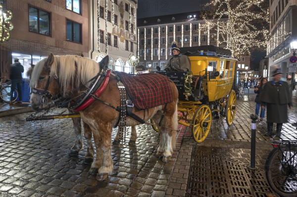 Horse-drawn carriage ride in a historic stagecoach at Chriskindlesmarkt, Hauptmarkt, Nuremberg,